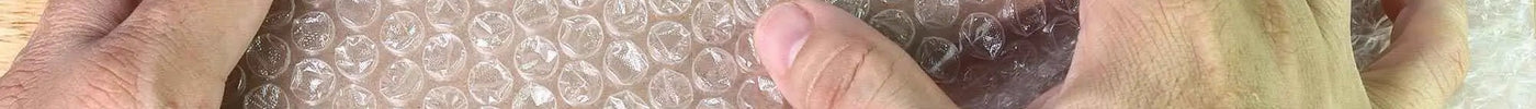 how to use bubble wrap - mage of a man placing a product wrapped in bubble wrap into a cardboard box