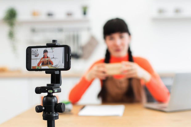 Young woman sharing and engaging with unboxing experience across social media, promoting social commerce