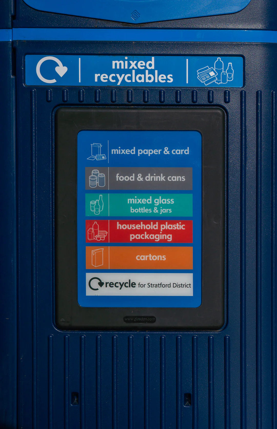 mixed recyclables sign in front of a recycling centre bin