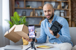 a man clearly unimpressed with how his camera was delivered, a plan brown box. 