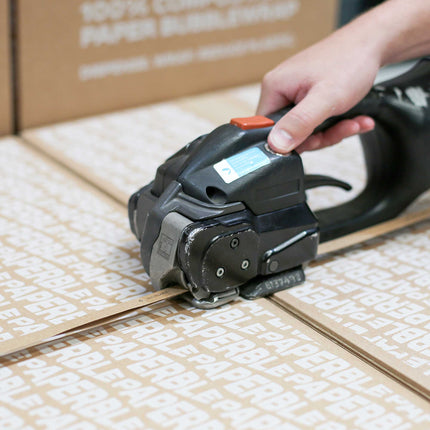Paper Strapping recyclable with friction strapping machine used in a warehouse