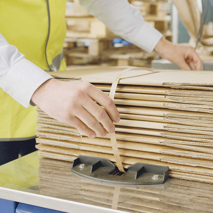 Paper Strapping recyclable with friction strapping machine used in a warehouse to pack a stack of cardboard boxes 0201
