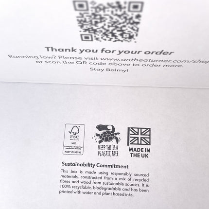 Inside ecommerce packaging crashlock boxes for cosmetics brand, with printed QR code, sustainability information, and branding elements.