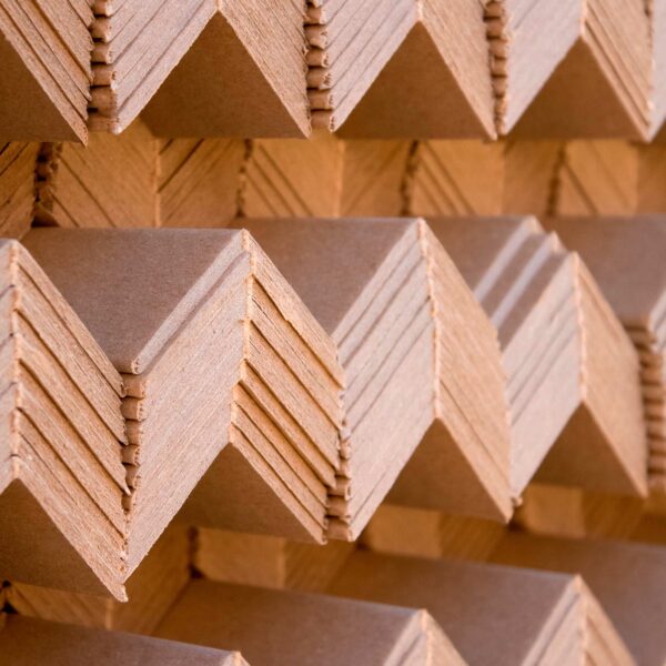 Cardboard Pallet Edge Protectors stacked up on top of one another.